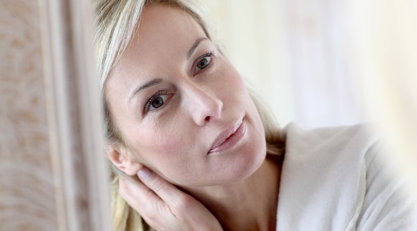 middle-aged woman and moisturizer